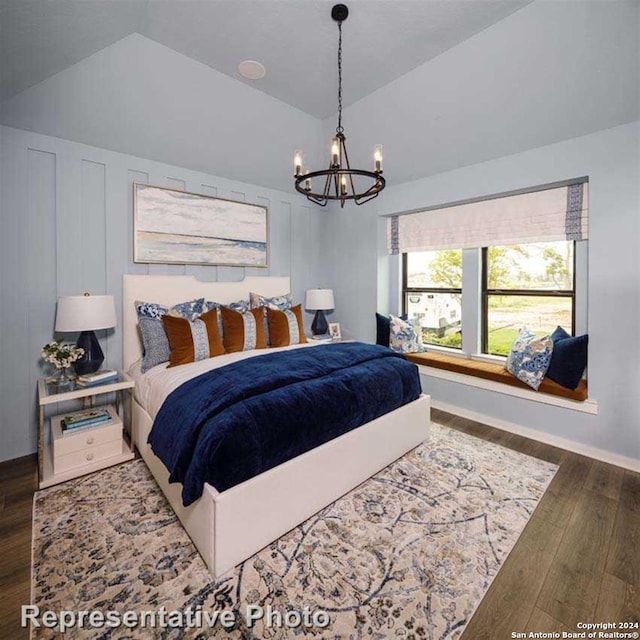 bedroom with a notable chandelier, lofted ceiling, and dark hardwood / wood-style flooring