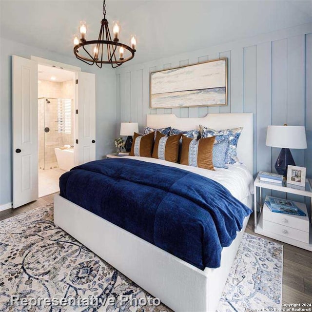 bedroom featuring ensuite bath, a chandelier, and wood-type flooring