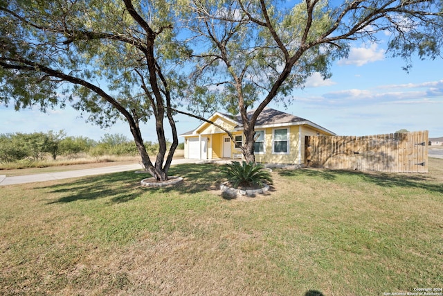 ranch-style home featuring a front lawn and a garage