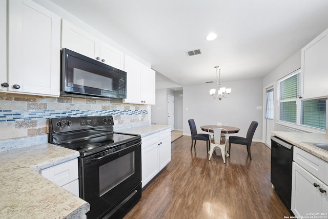 kitchen featuring dark hardwood / wood-style floors, a notable chandelier, hanging light fixtures, black appliances, and white cabinetry