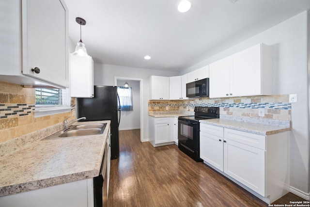 kitchen with white cabinets, hanging light fixtures, sink, black appliances, and dark hardwood / wood-style flooring