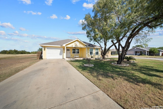 ranch-style home featuring a garage and a front lawn