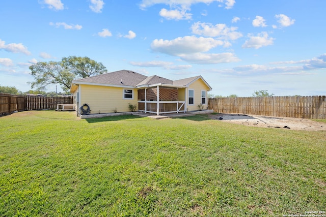 rear view of property with a patio and a yard