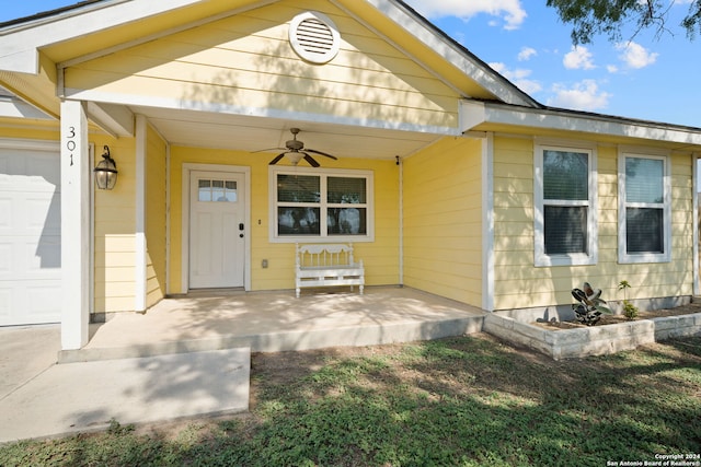 doorway to property featuring a garage and ceiling fan