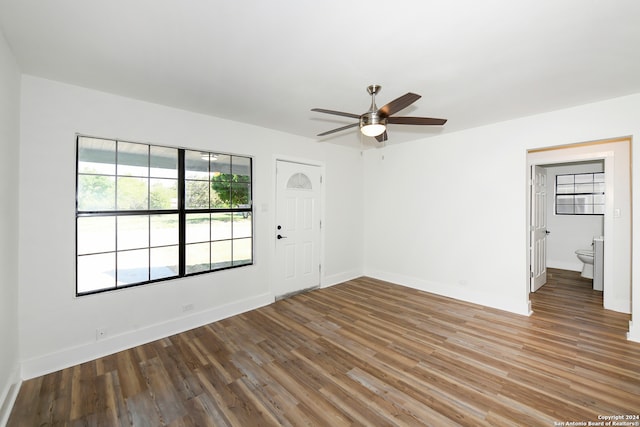 empty room with hardwood / wood-style flooring and ceiling fan