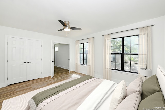 bedroom with a closet, ceiling fan, and hardwood / wood-style floors