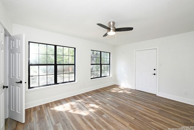 empty room featuring hardwood / wood-style flooring and ceiling fan