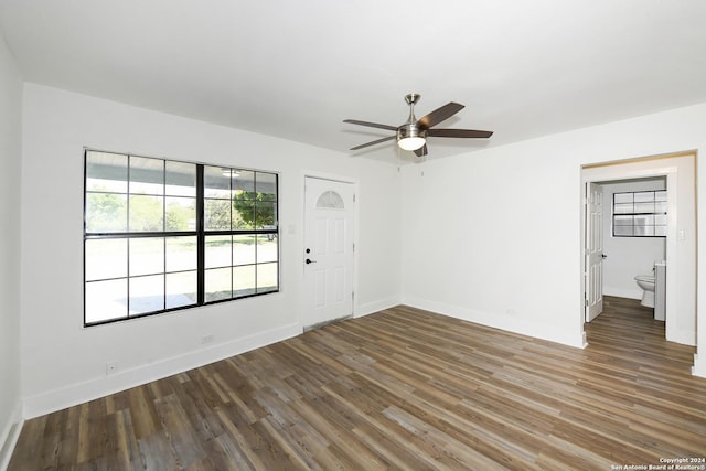 interior space featuring wood finished floors, a ceiling fan, and baseboards