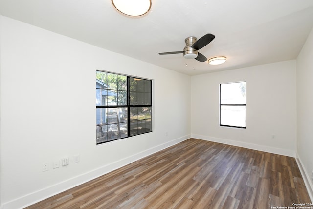 unfurnished room featuring ceiling fan and dark hardwood / wood-style flooring