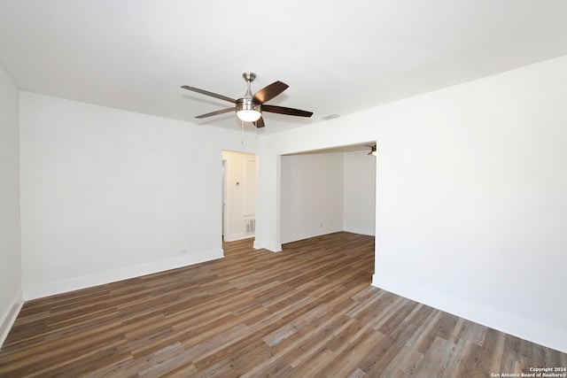 unfurnished room featuring ceiling fan and dark hardwood / wood-style flooring