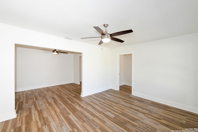 unfurnished room featuring hardwood / wood-style floors and ceiling fan