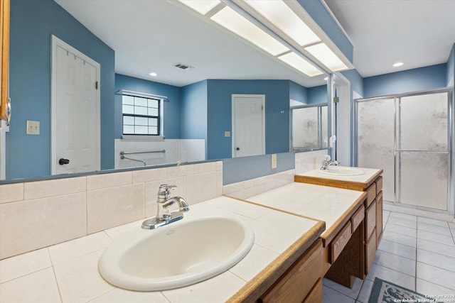 bathroom with an enclosed shower, tile patterned flooring, and vanity