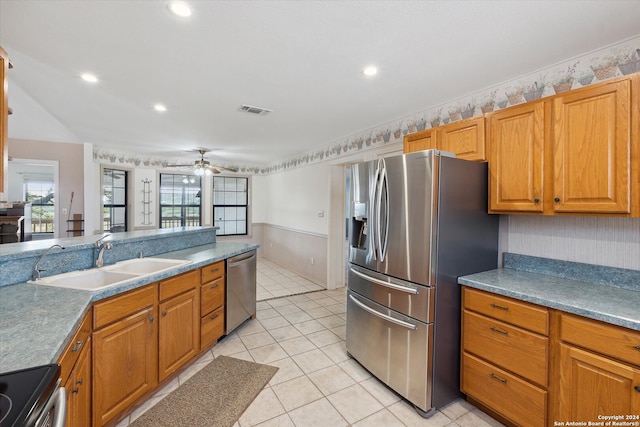 kitchen with stainless steel appliances, sink, light tile patterned floors, and ceiling fan