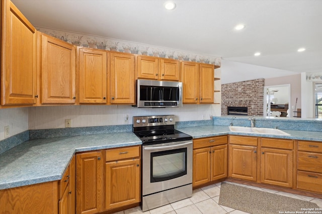 kitchen featuring light tile patterned floors, sink, and stainless steel appliances