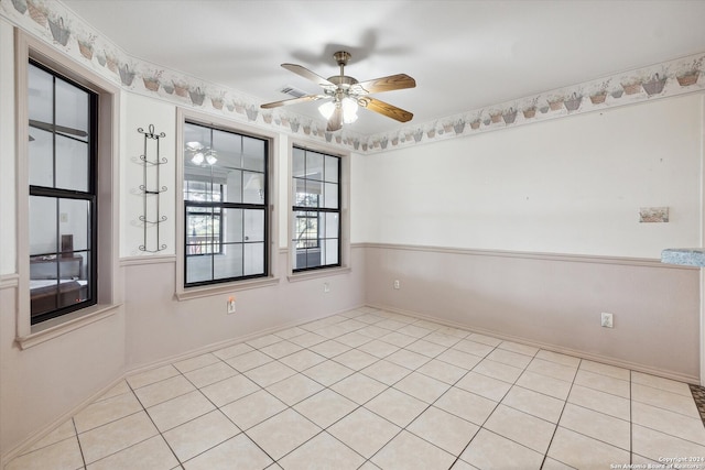 empty room with light tile patterned flooring and ceiling fan