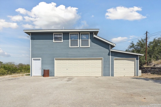 view of side of home featuring a garage