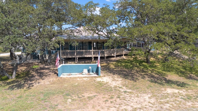 rear view of property with a wooden deck