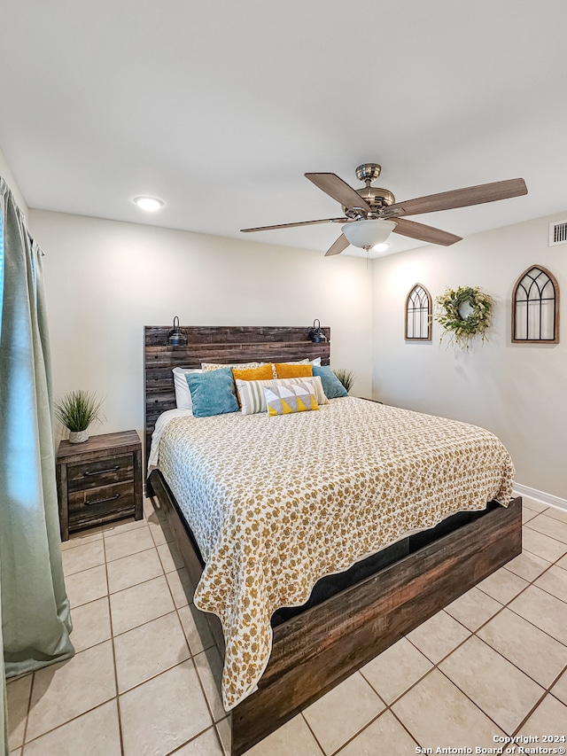 bedroom with ceiling fan and light tile patterned flooring