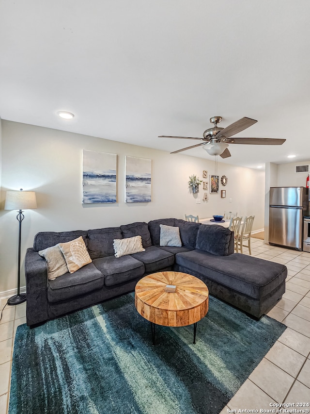 tiled living room with ceiling fan