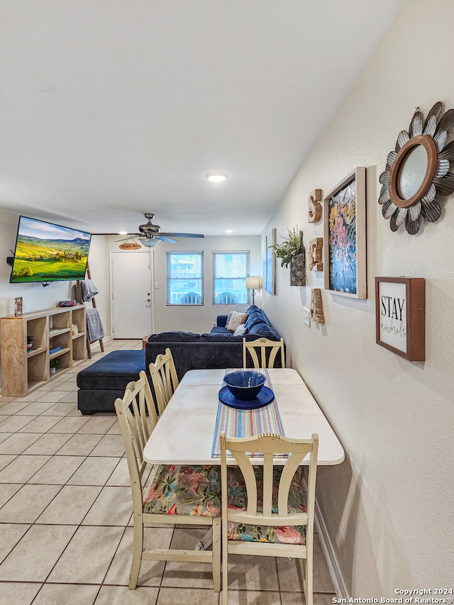 tiled dining room featuring ceiling fan