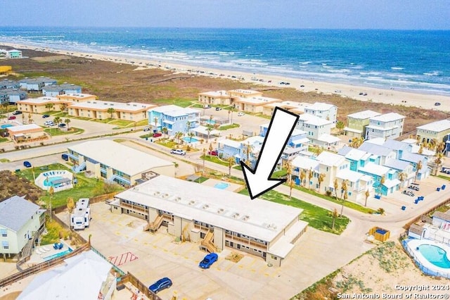 bird's eye view featuring a water view and a view of the beach