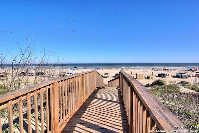 view of property's community with a water view and a view of the beach