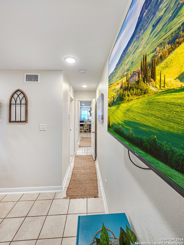 hall featuring light tile patterned floors