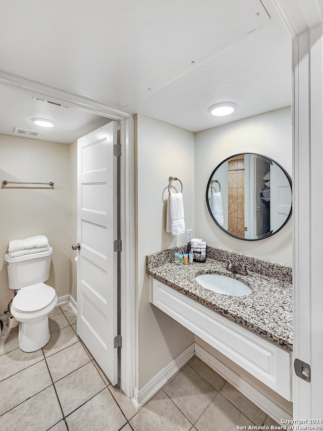 bathroom featuring tile patterned flooring, sink, and toilet