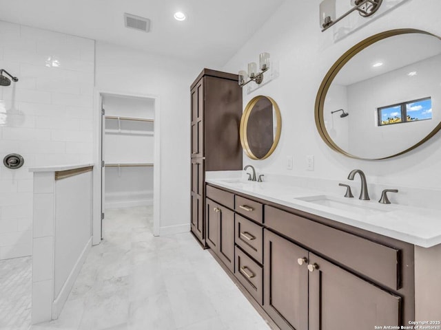 bathroom featuring vanity and walk in shower