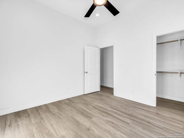 unfurnished bedroom with ceiling fan, light hardwood / wood-style floors, and a closet