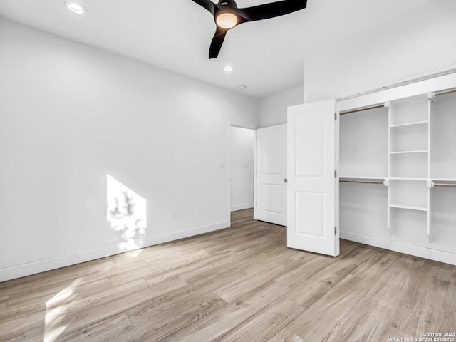 unfurnished bedroom with ceiling fan, a closet, and light hardwood / wood-style flooring