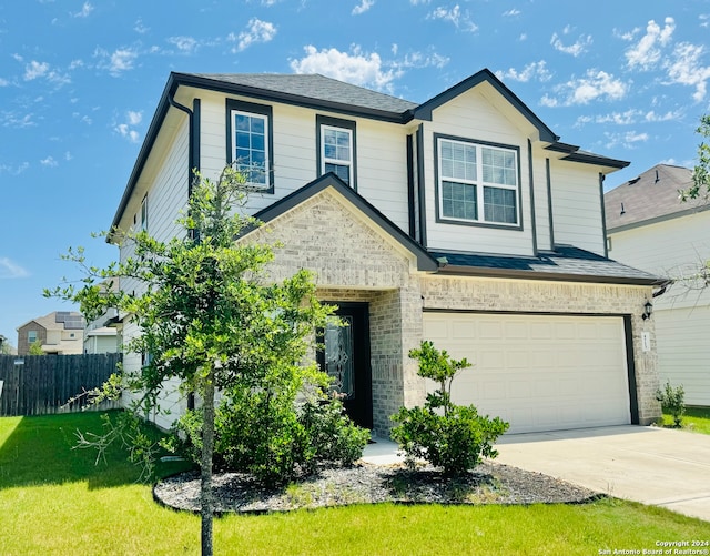 view of front of home featuring a garage and a front yard