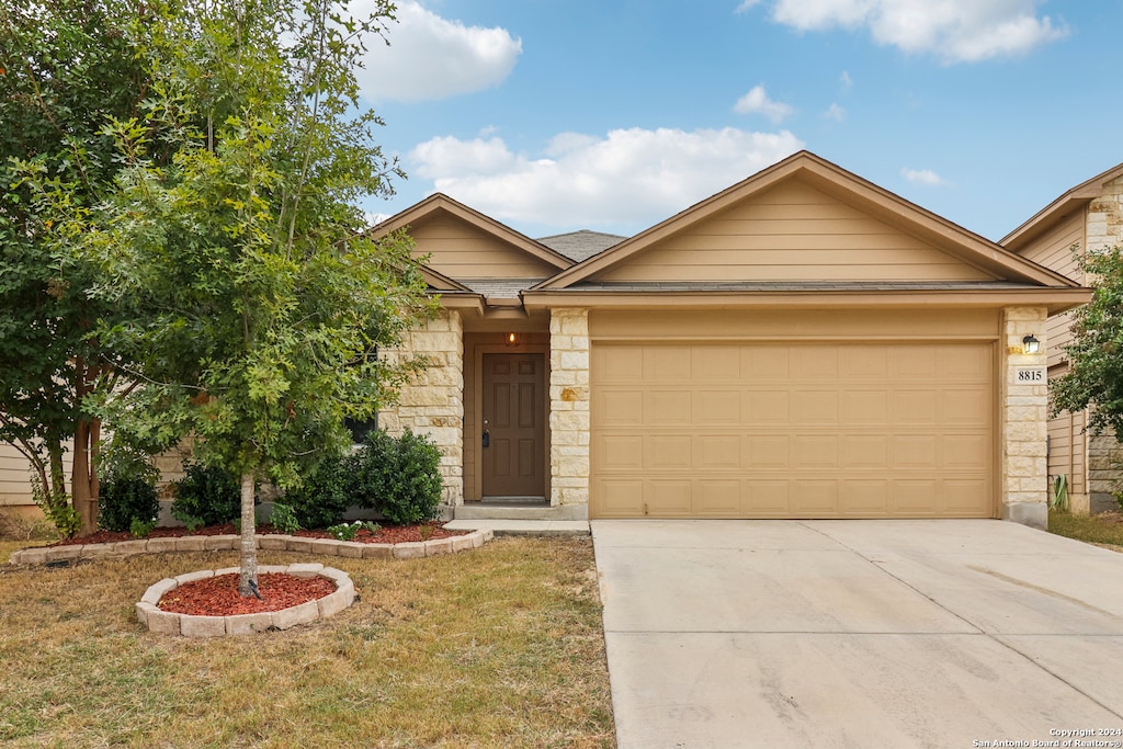 view of front of home with a front lawn and a garage