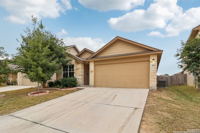 view of front of house with central AC, a garage, and a front yard