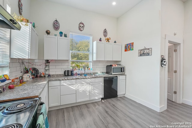 kitchen featuring extractor fan, white cabinets, appliances with stainless steel finishes, and light wood-type flooring