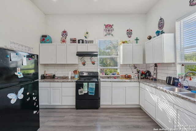 kitchen with tasteful backsplash, black appliances, sink, and white cabinets