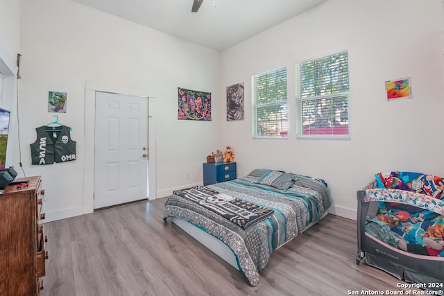 bedroom with light wood-type flooring and ceiling fan