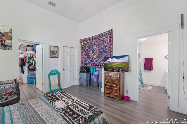 bedroom with a closet and hardwood / wood-style floors