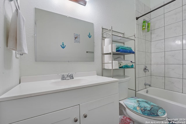 full bathroom featuring tiled shower / bath combo, vanity, and toilet