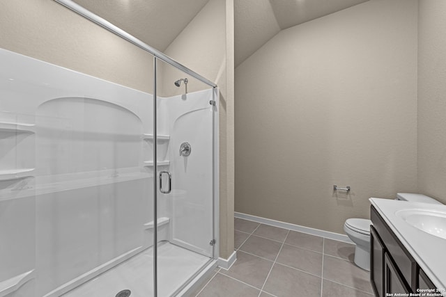 bathroom featuring vaulted ceiling, vanity, an enclosed shower, toilet, and tile patterned floors