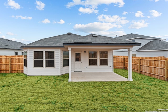 rear view of house featuring a yard and a patio