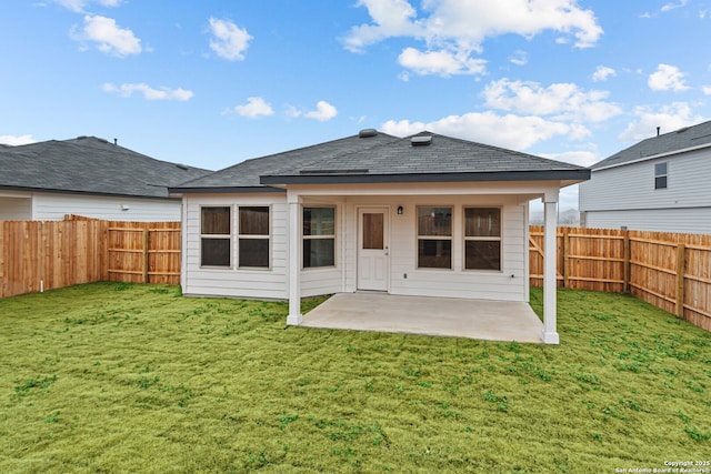 rear view of property featuring a yard and a patio