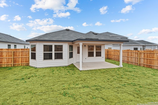 rear view of property featuring a patio area and a lawn