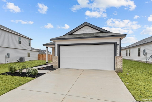 garage with a yard and central AC unit