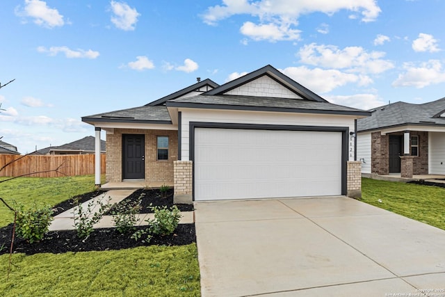 view of front facade with a garage and a front lawn