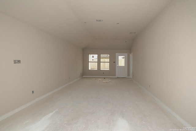 unfurnished room featuring lofted ceiling