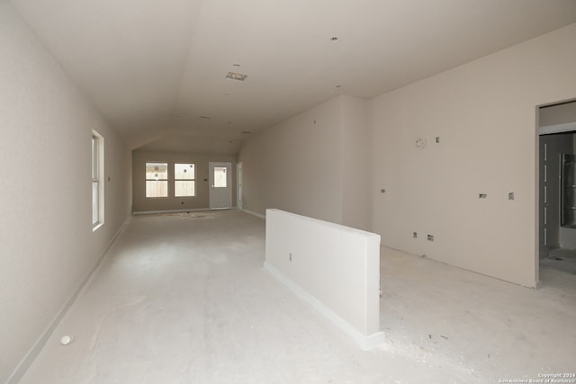 unfurnished room with vaulted ceiling