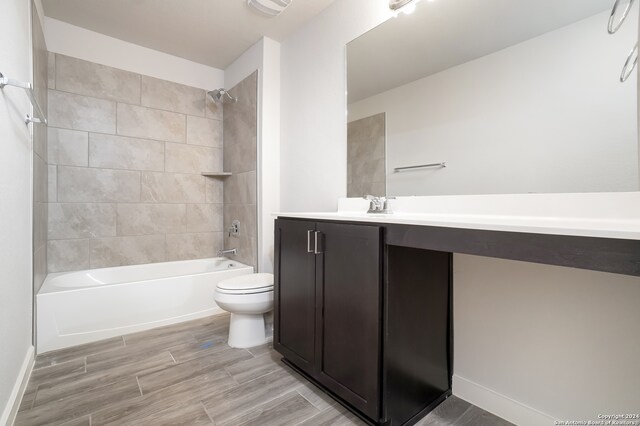 full bathroom with tiled shower / bath combo, vanity, and toilet