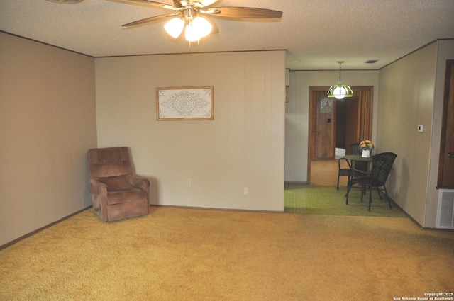 105 S Sayers Dr, Devine, TX 78016 - unfurnished room featuring carpet flooring, a textured ceiling, ceiling fan, and baseboards