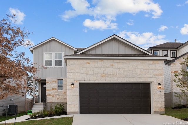 view of front of home featuring a garage and central AC unit